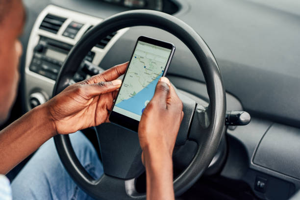 Cropped shot of an unrecognizable using the GPS system on his smartphone while driving around in his car